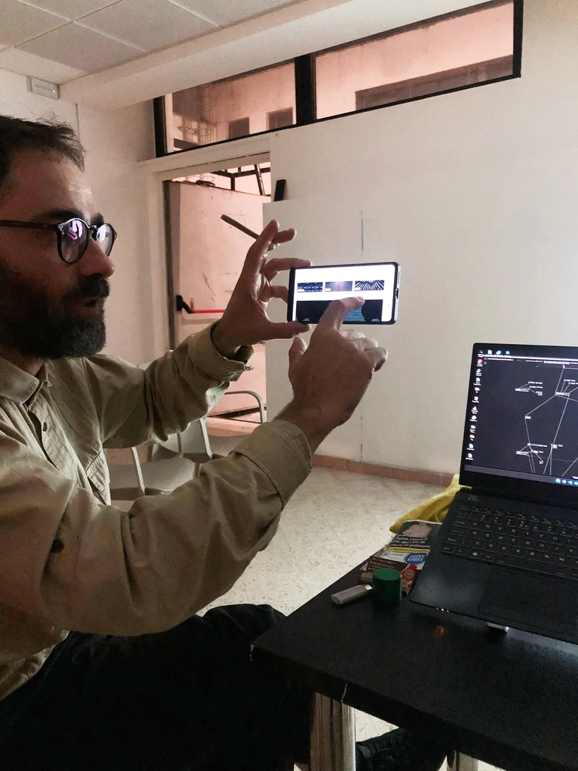 Picture of Alessandro from La Scuola Open Source showing a work on their smartphone.