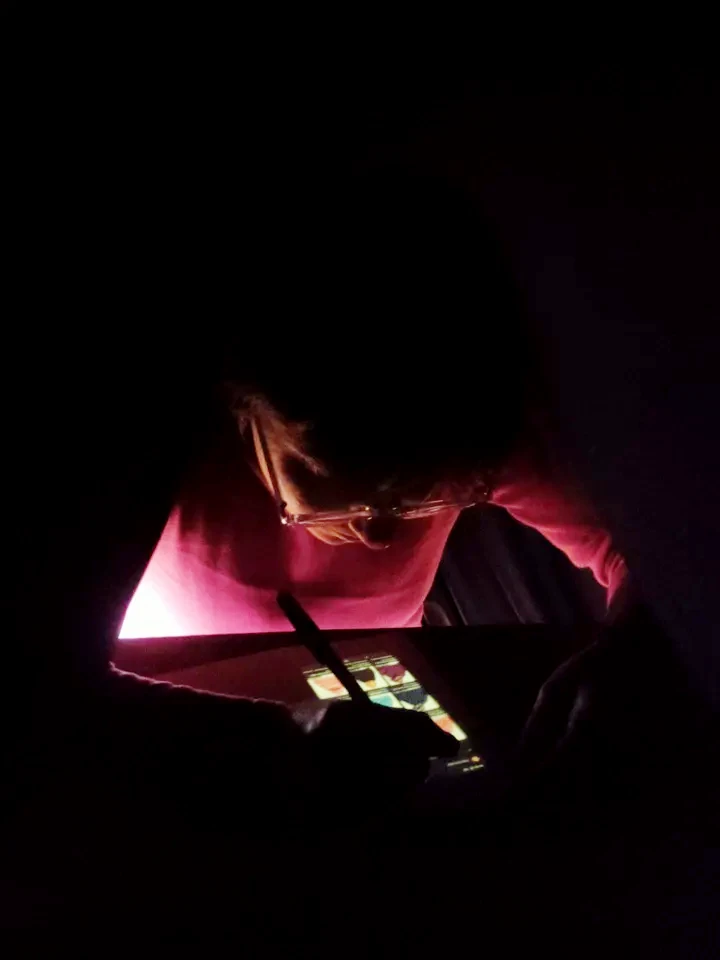 Only lit by the dim display of the smartphones