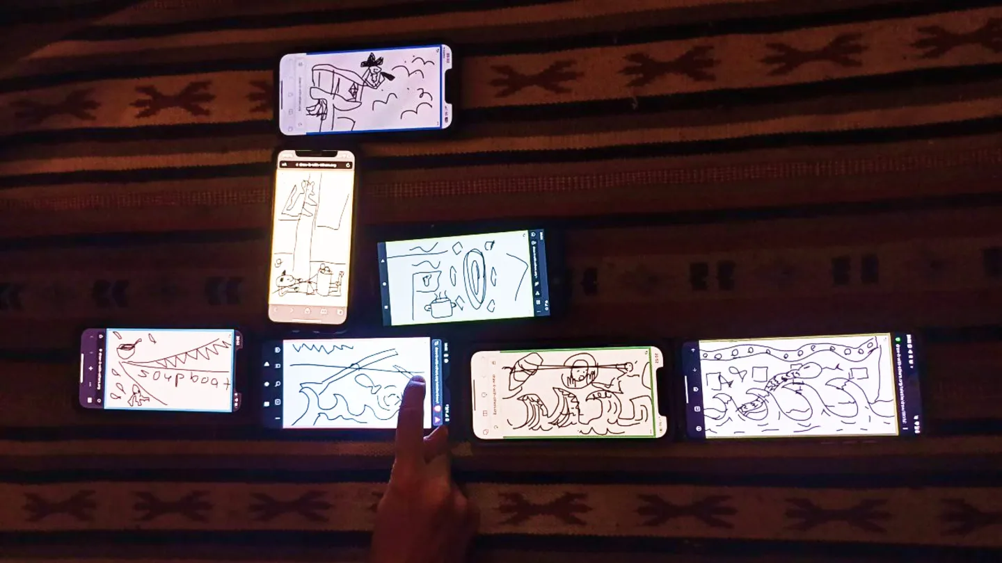 Seven phones on a carpet configured using teletile in a shape that could be a sailing boat. In the drawing some waves and parts of a ship are recognizable.